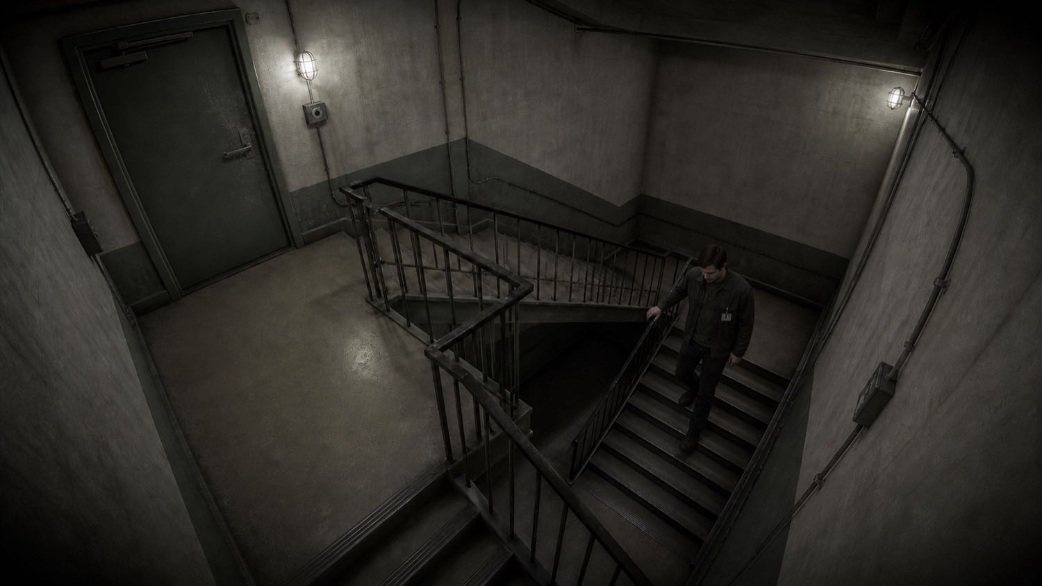 Elliot on the lower stairwell, lit from above